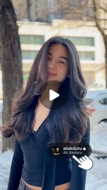 Long layered brunette hair shown in Ali Akduru’s Instagram reel